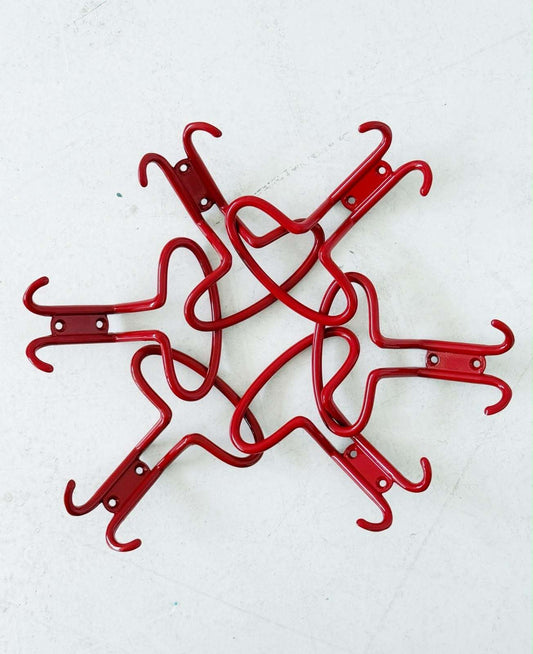 Set of six red metal wall hooks
