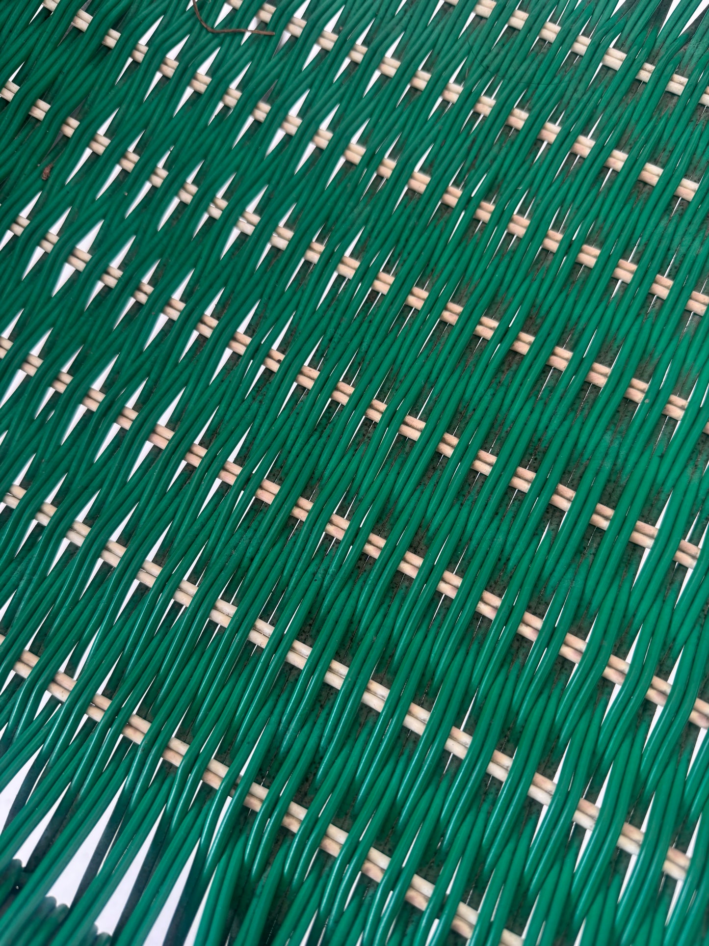 Green woven chair with armrests