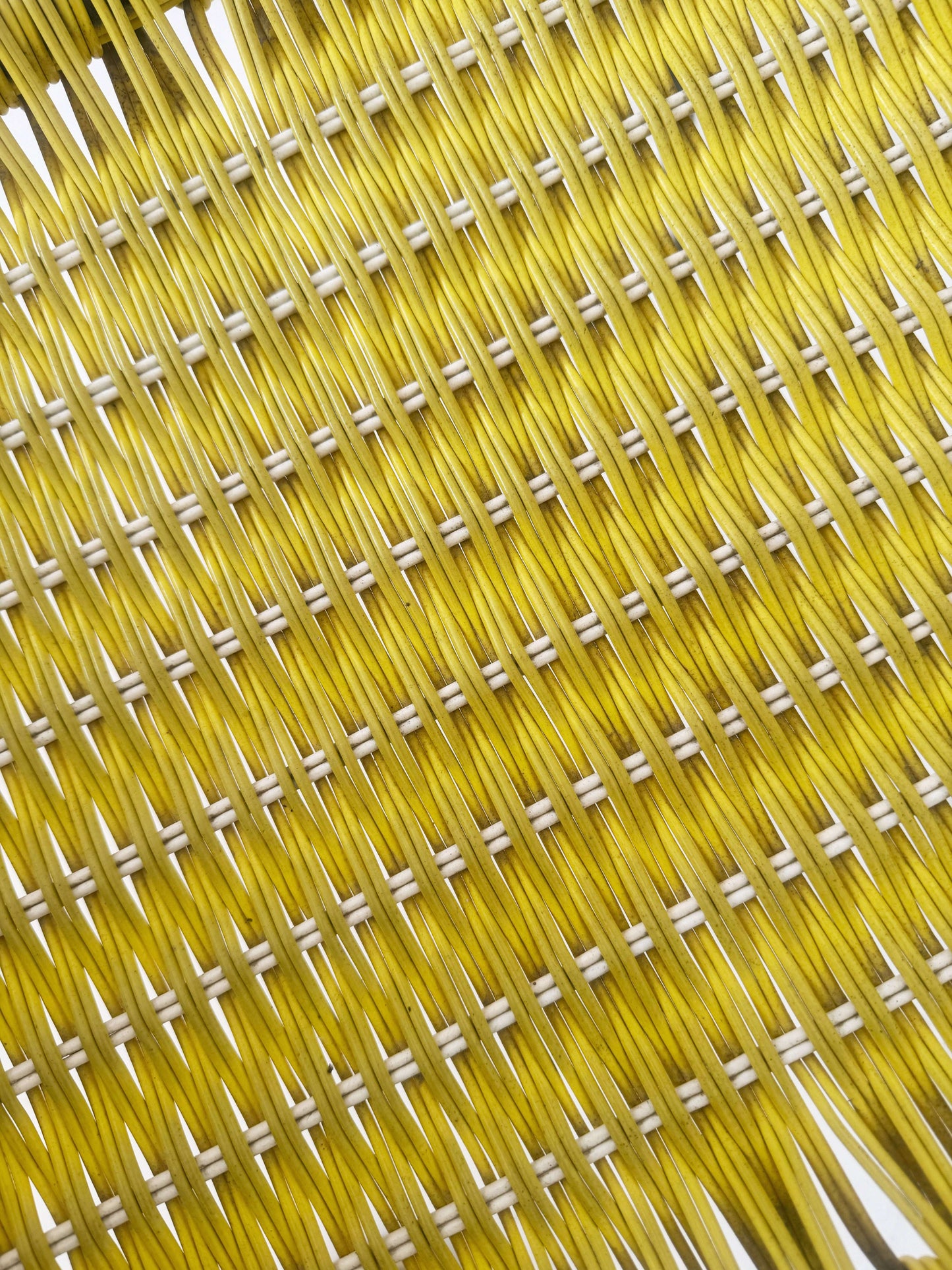 Yellow woven chair with armrests