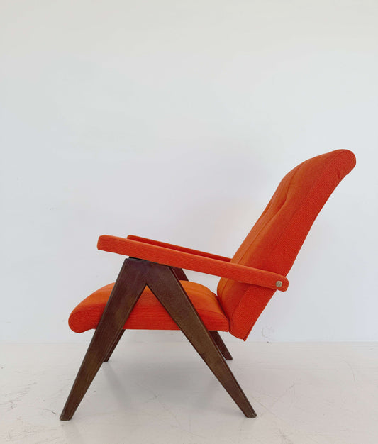 A vintage reclining armchair, dating back to European production in the 1950s and 1960s