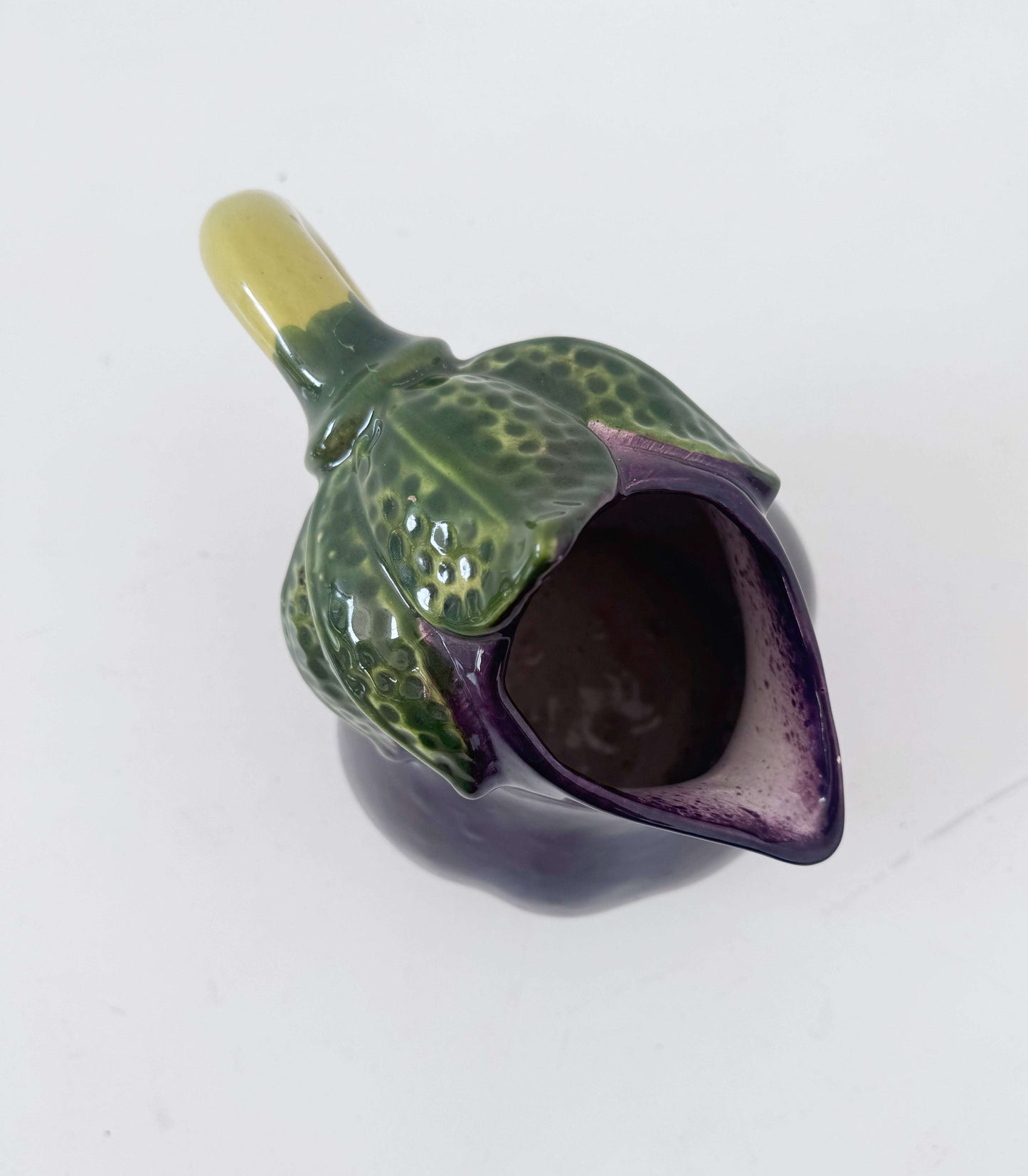 Glazed ceramic pitcher shaped like an eggplant
