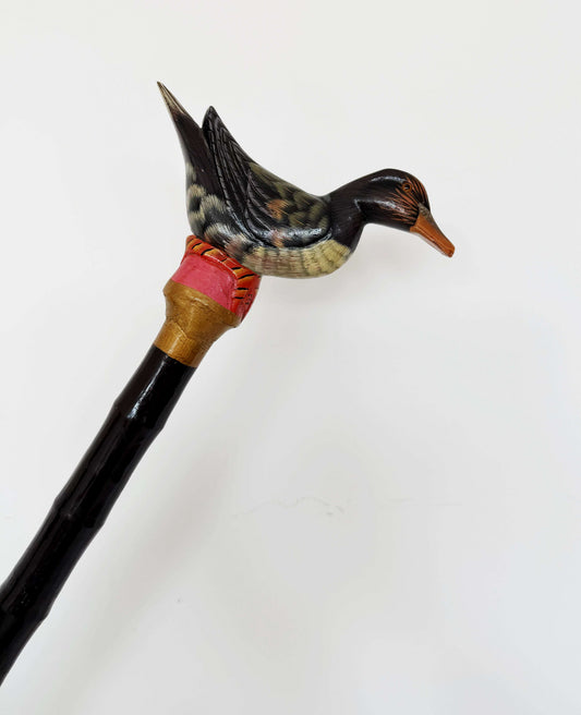 Black vintage walking stick with a decorative duck
