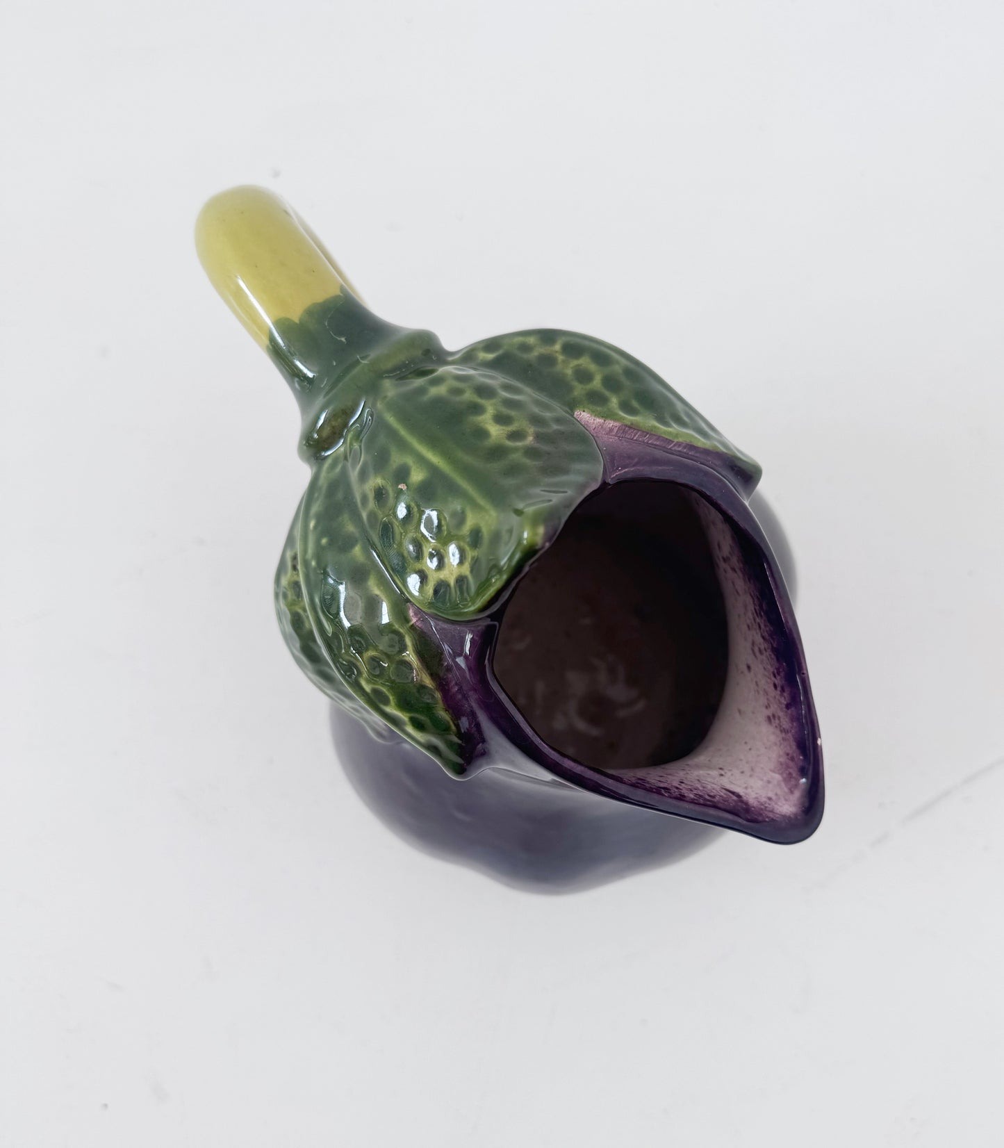 Glazed ceramic pitcher shaped like an eggplant