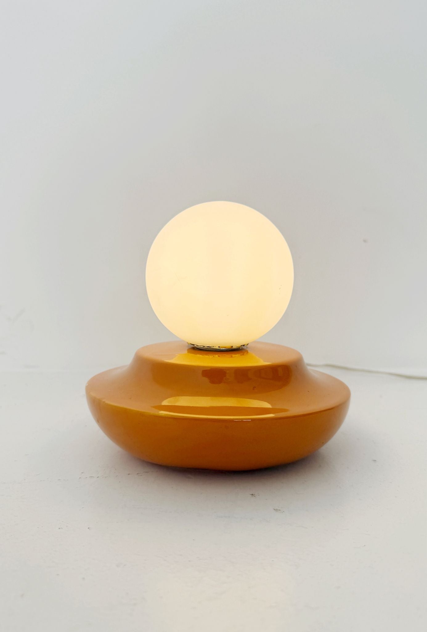 Orange glazed ceramic and opal glass table lamp