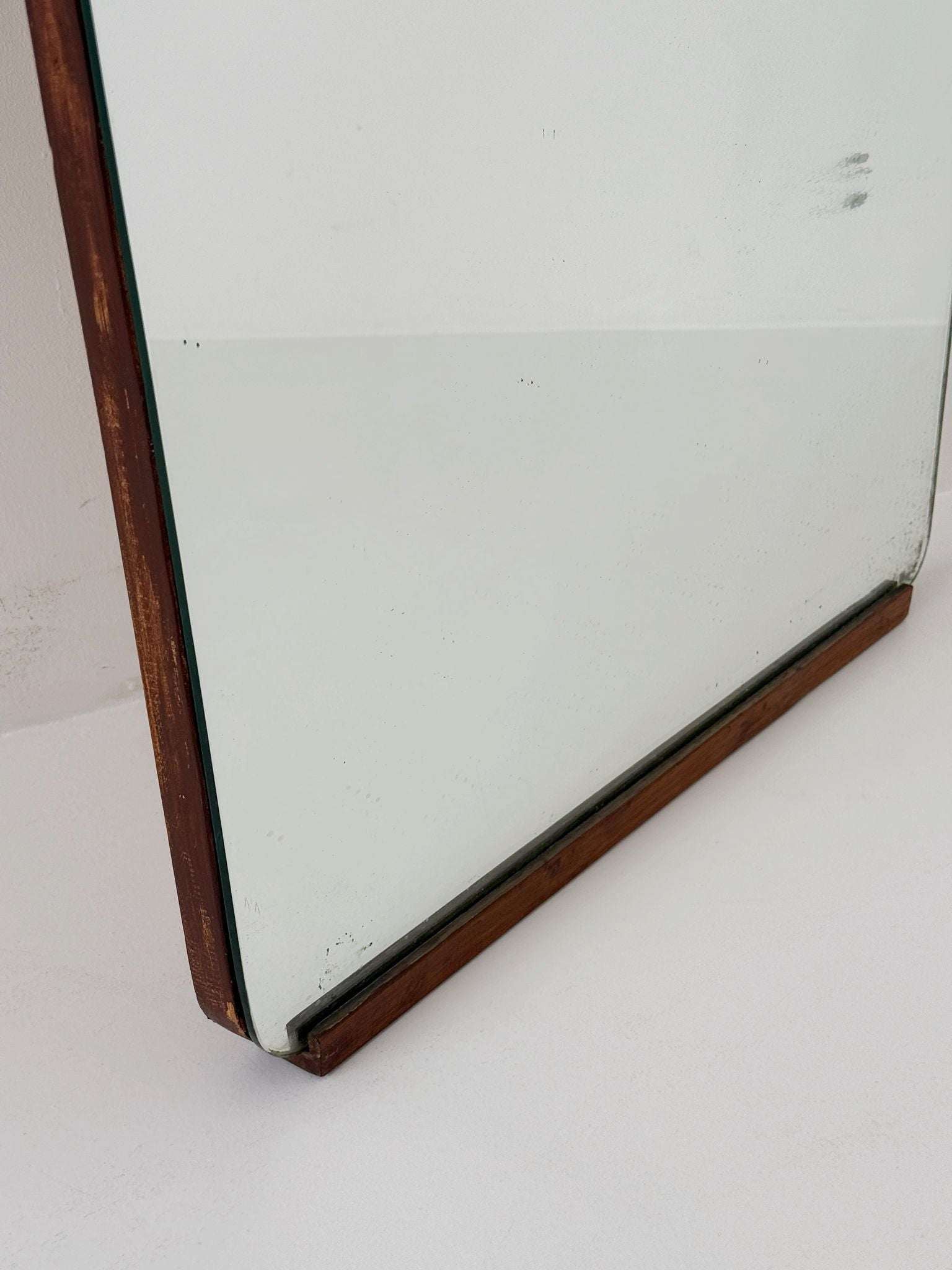 Shaped wall mirror with wooden edge