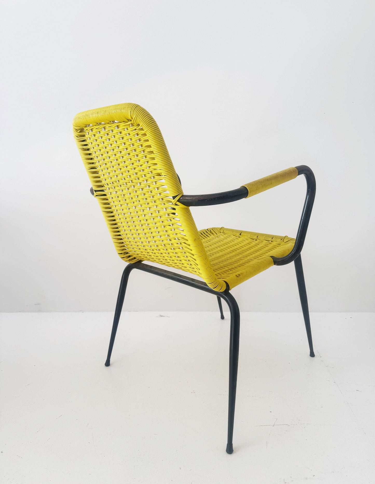 Yellow woven chair with armrests