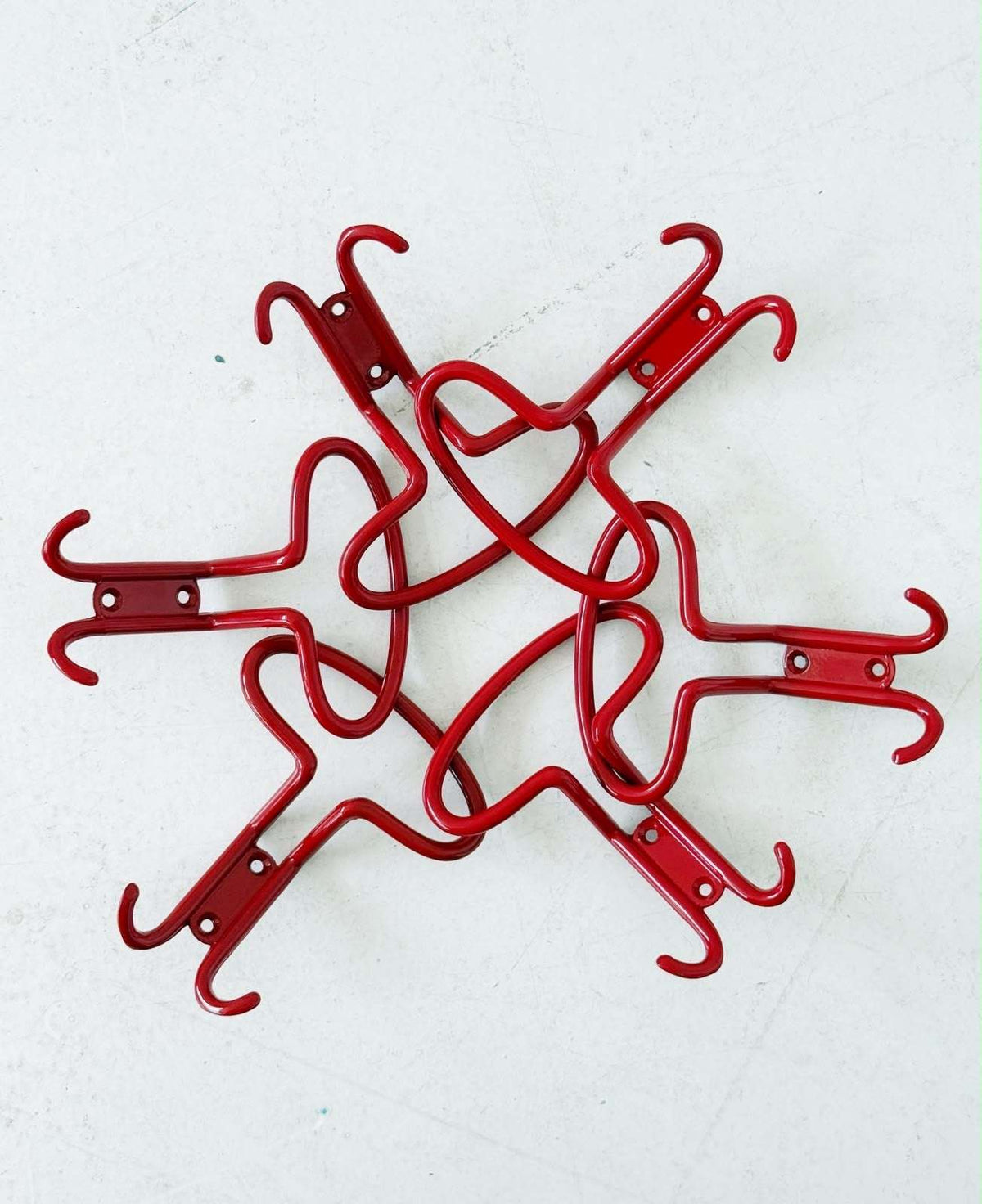 Set of six red metal wall hooks