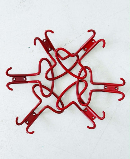 Set of six red metal wall hooks