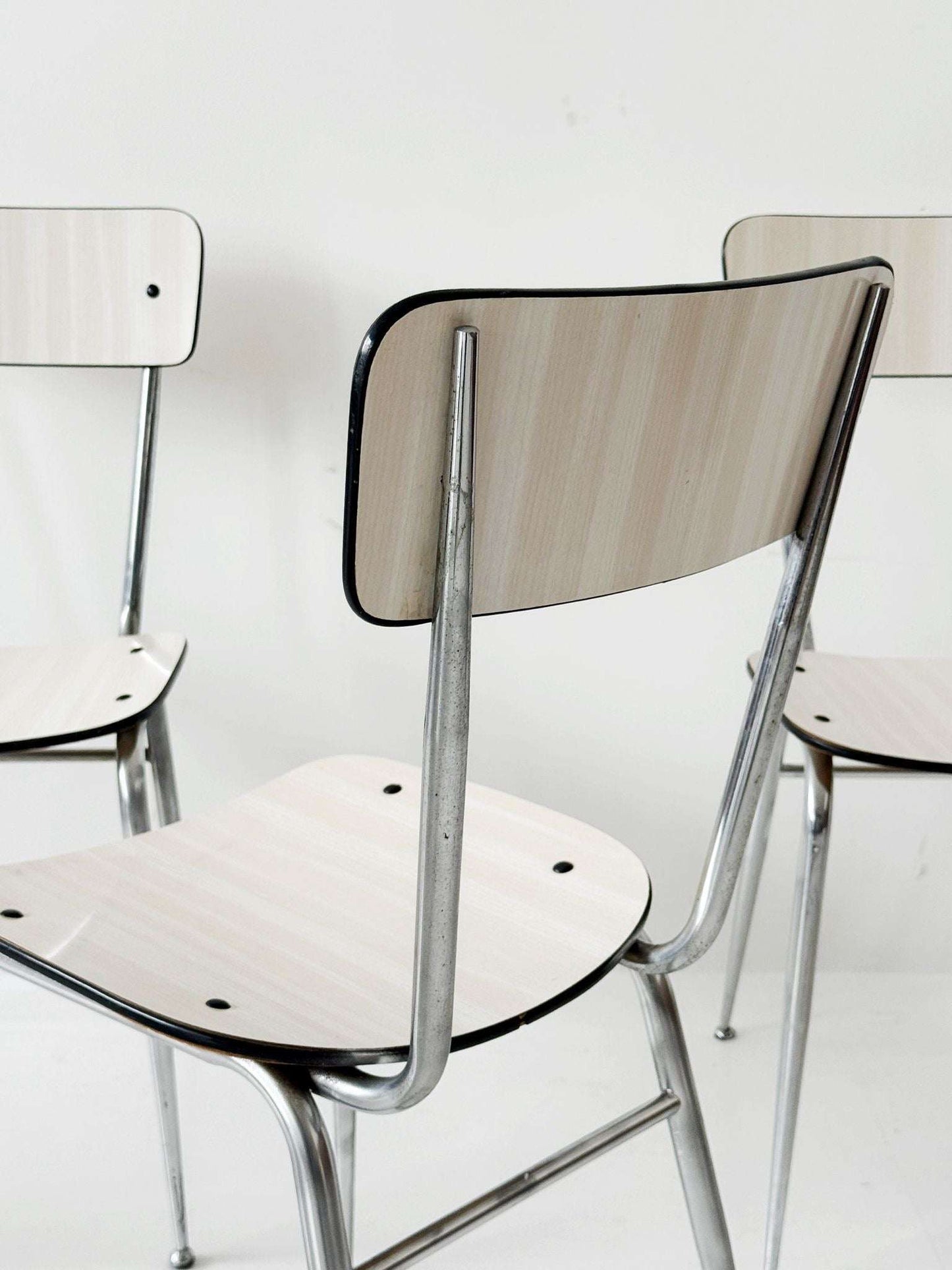 Three beige formica chairs