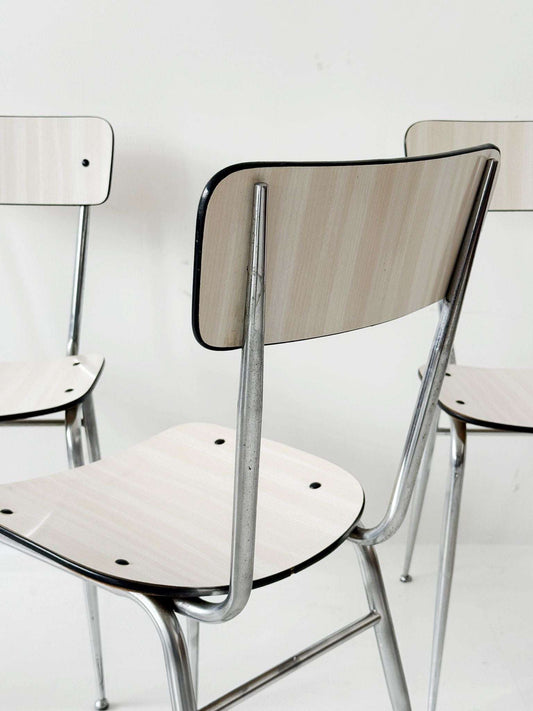 Three beige formica chairs