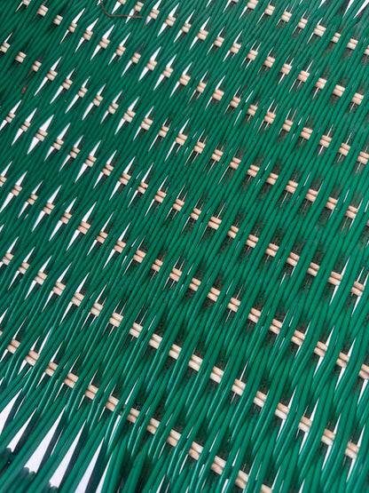 Green woven chair with armrests