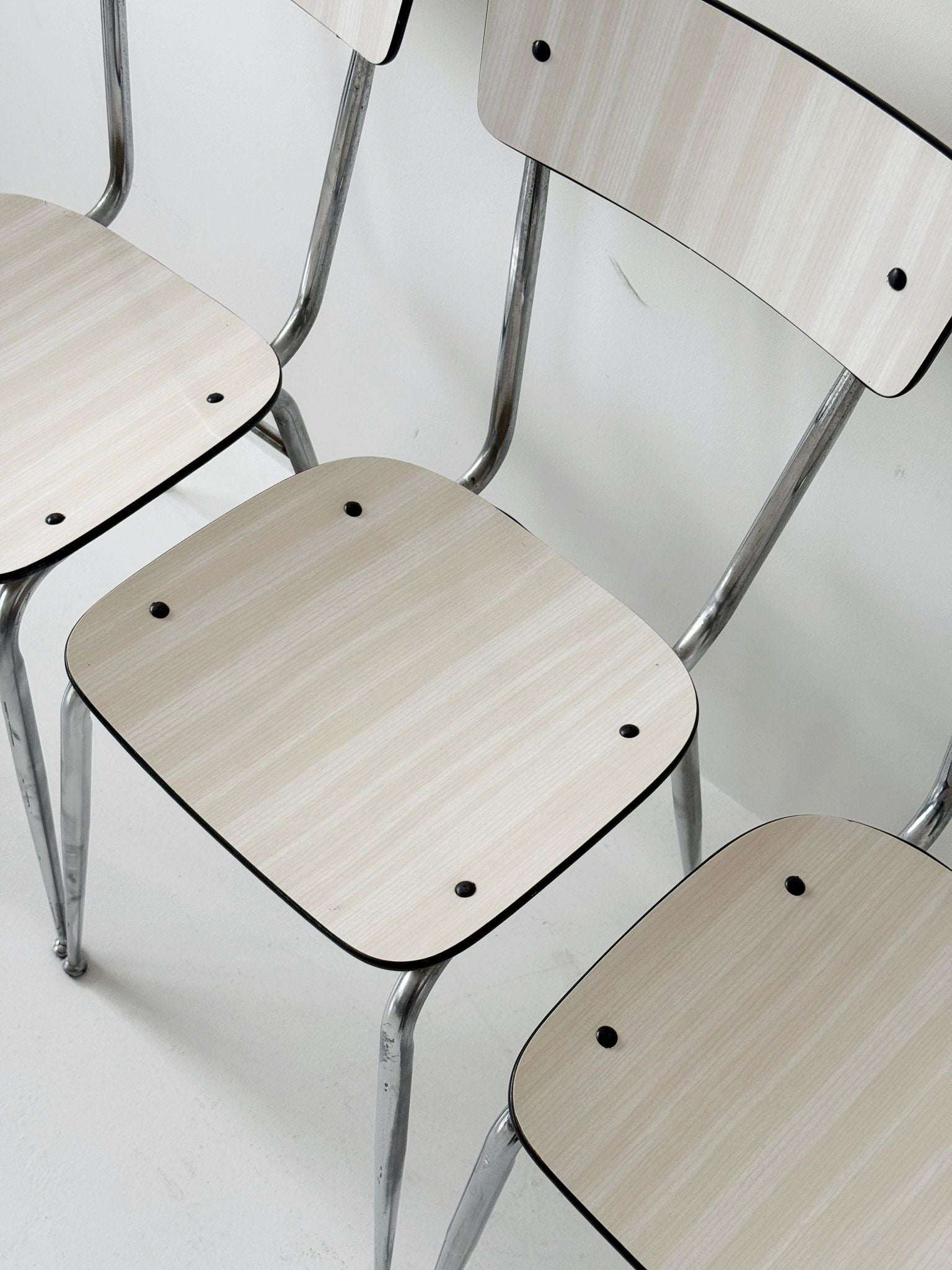 Three beige formica chairs
