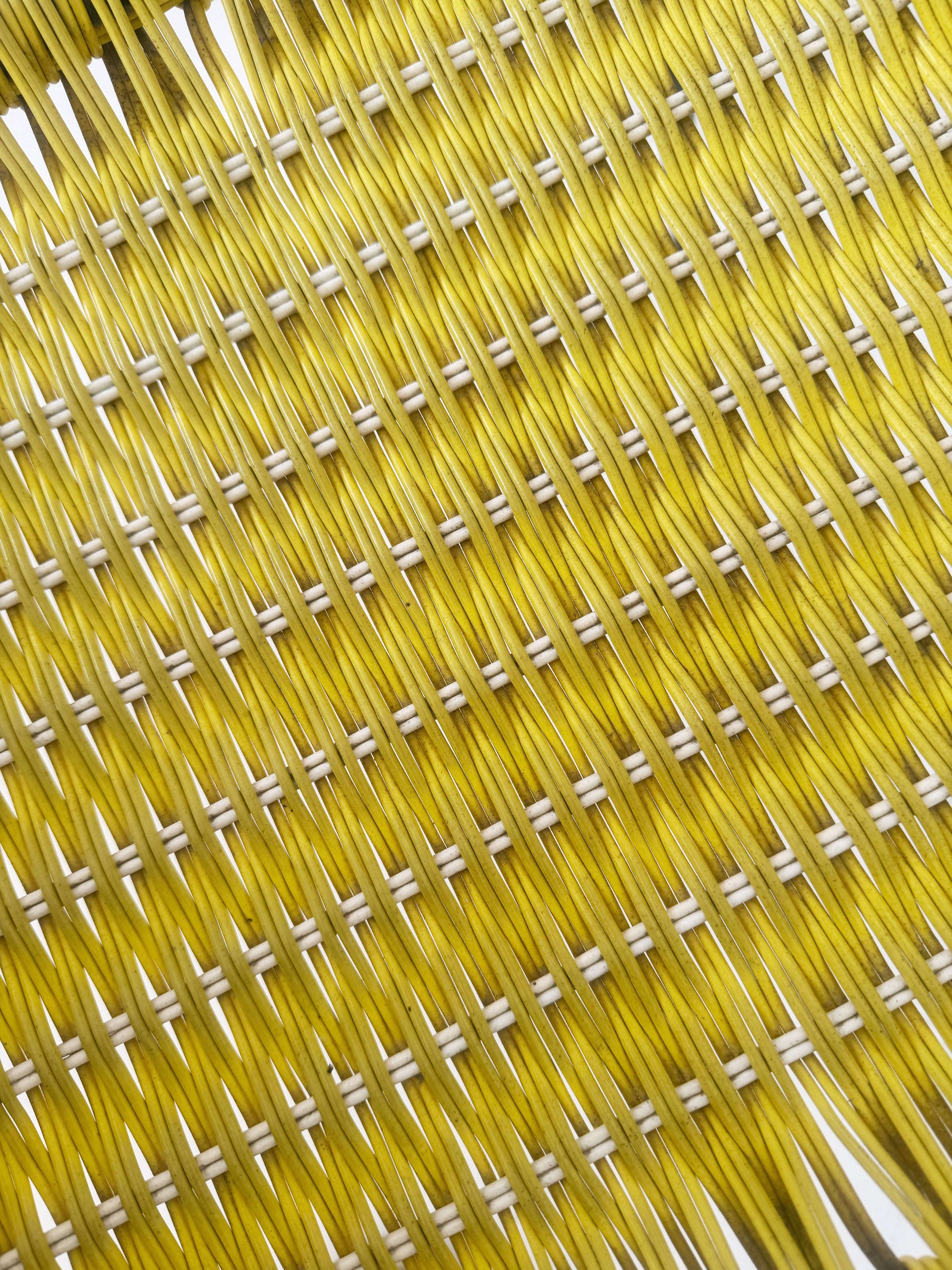 Yellow woven chair with armrests