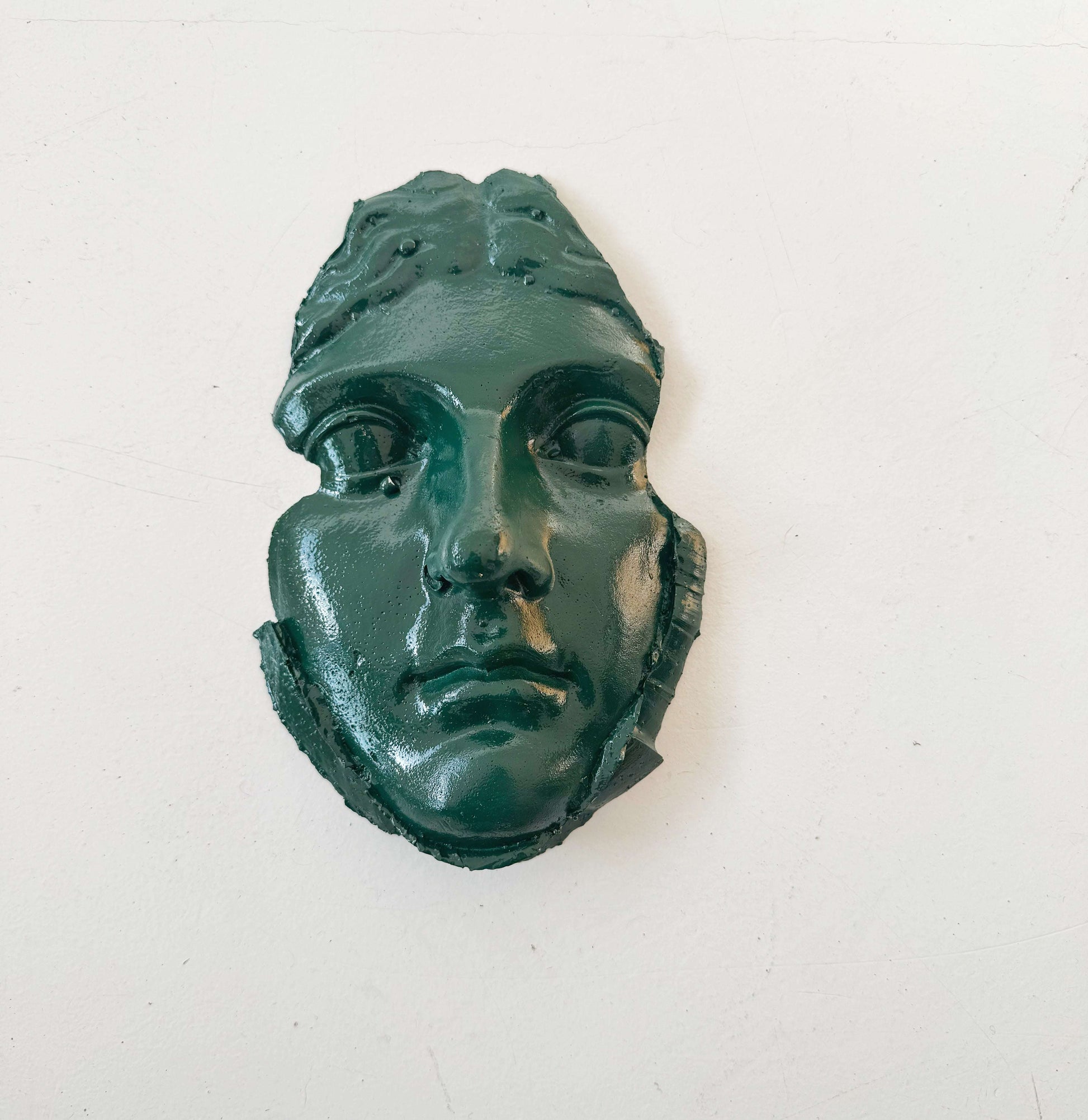 A plaster fragment depicting a female face