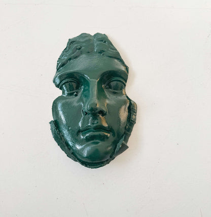 A plaster fragment depicting a female face