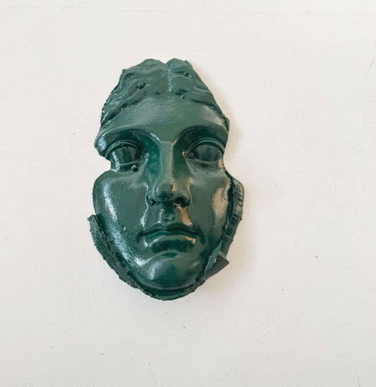 A plaster fragment depicting a female face