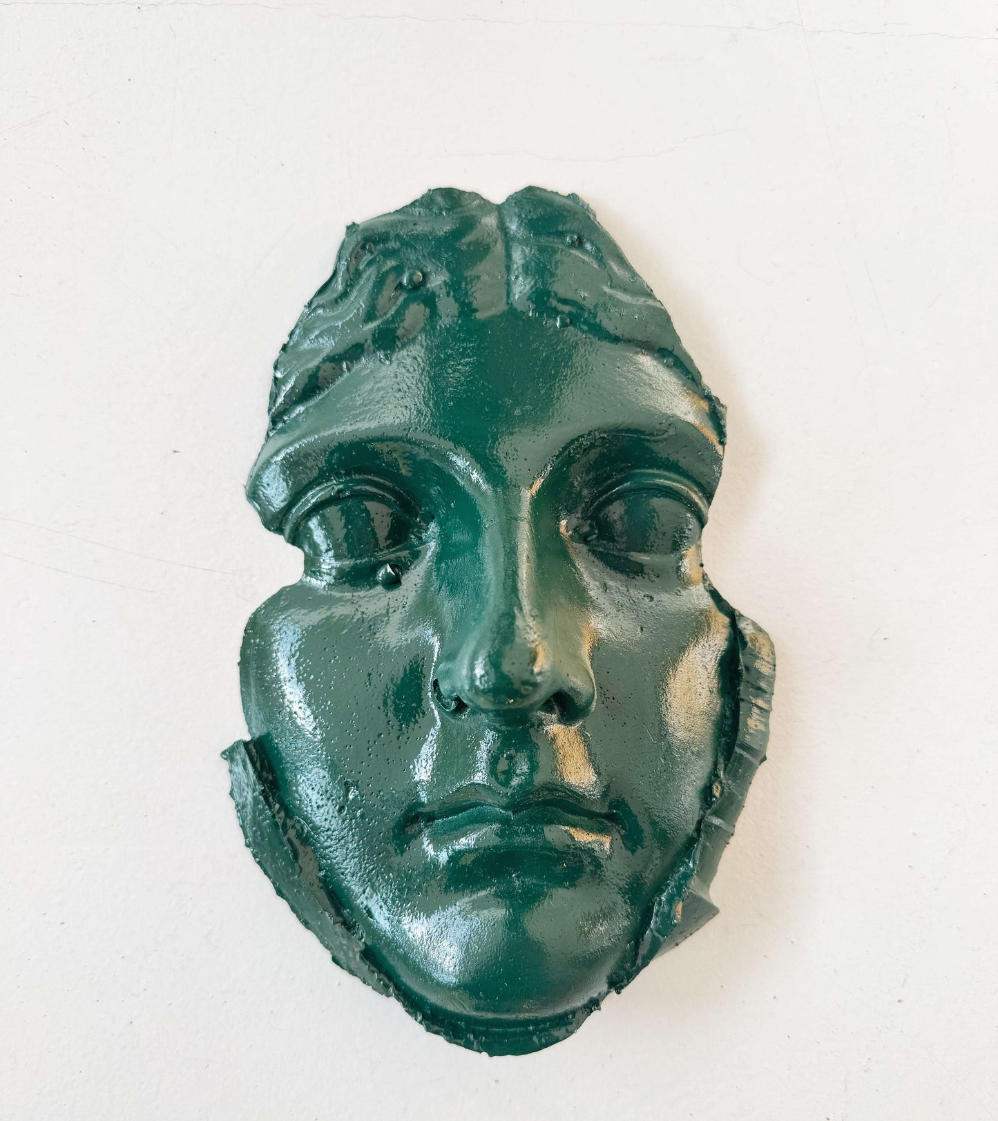 A plaster fragment depicting a female face