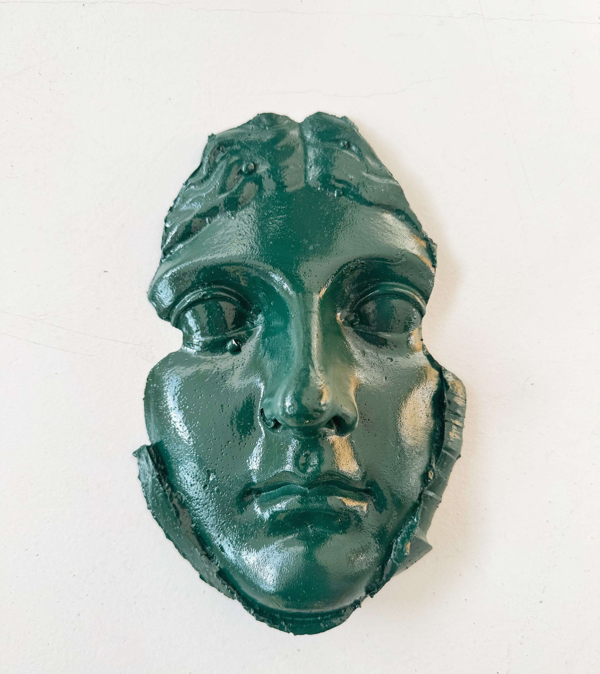 A plaster fragment depicting a female face