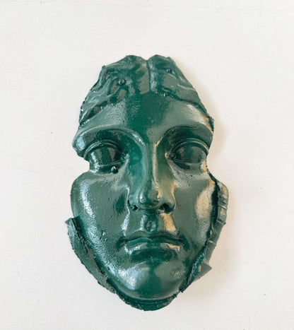 A plaster fragment depicting a female face