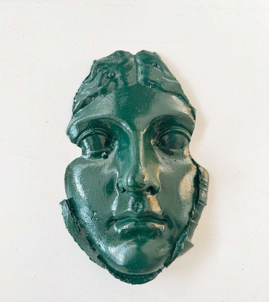 A plaster fragment depicting a female face