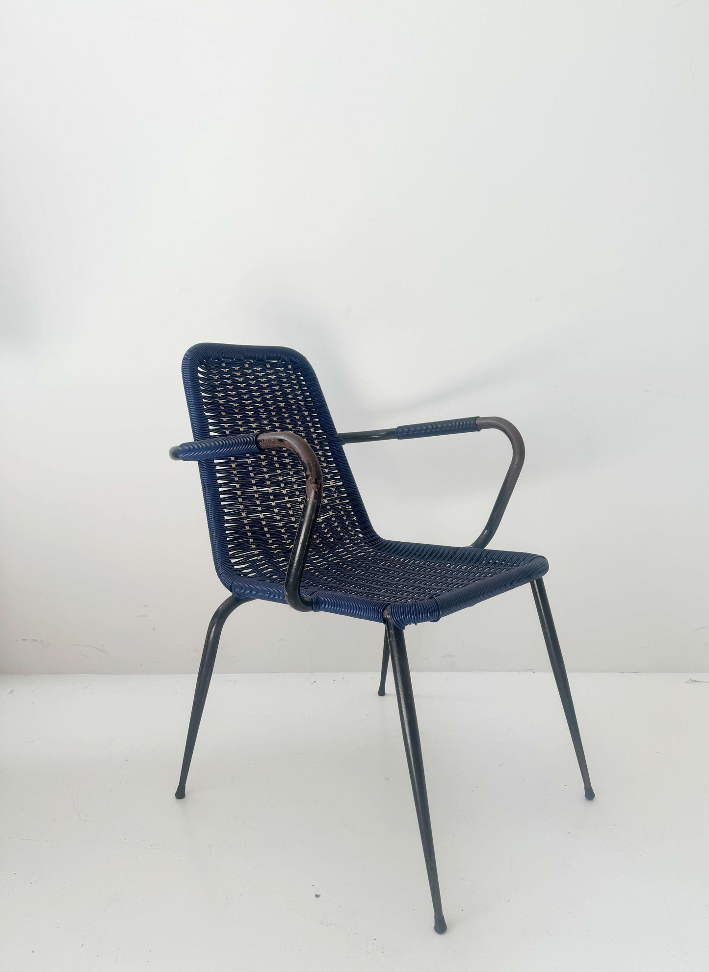 Blue woven chair with armrests
