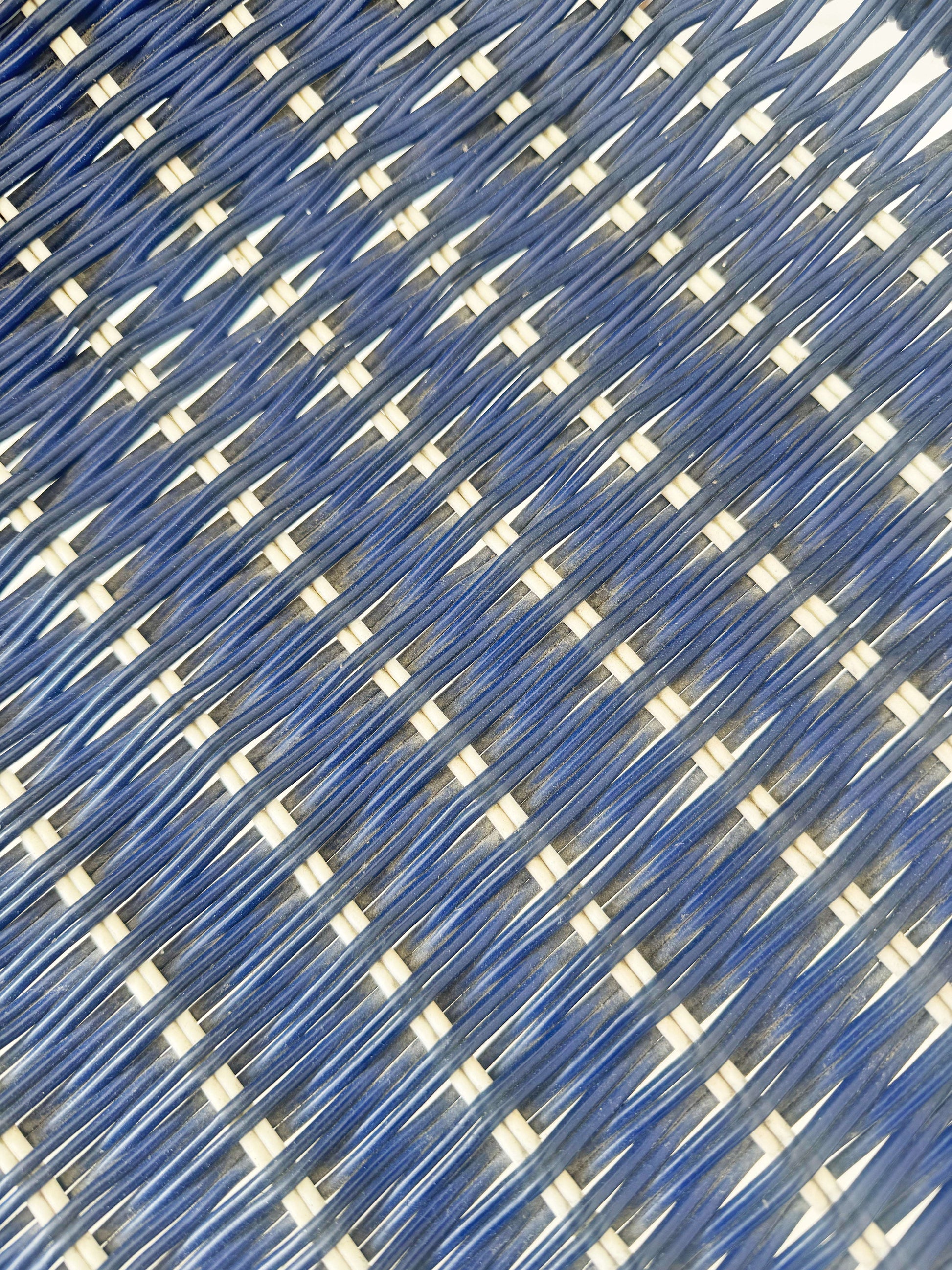 Blue woven chair with armrests