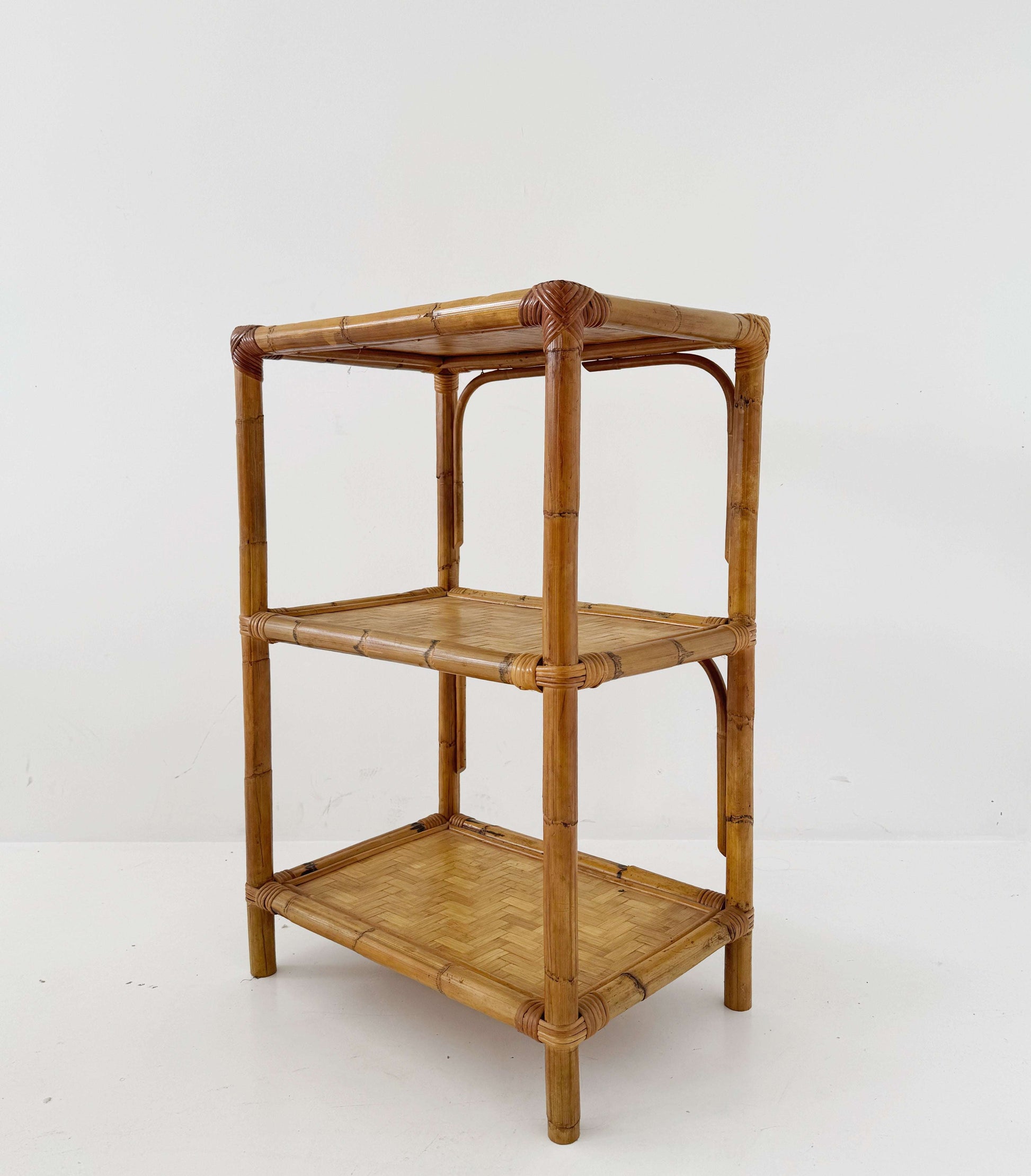 A 1970s bamboo bookcase with three shelves and woven details