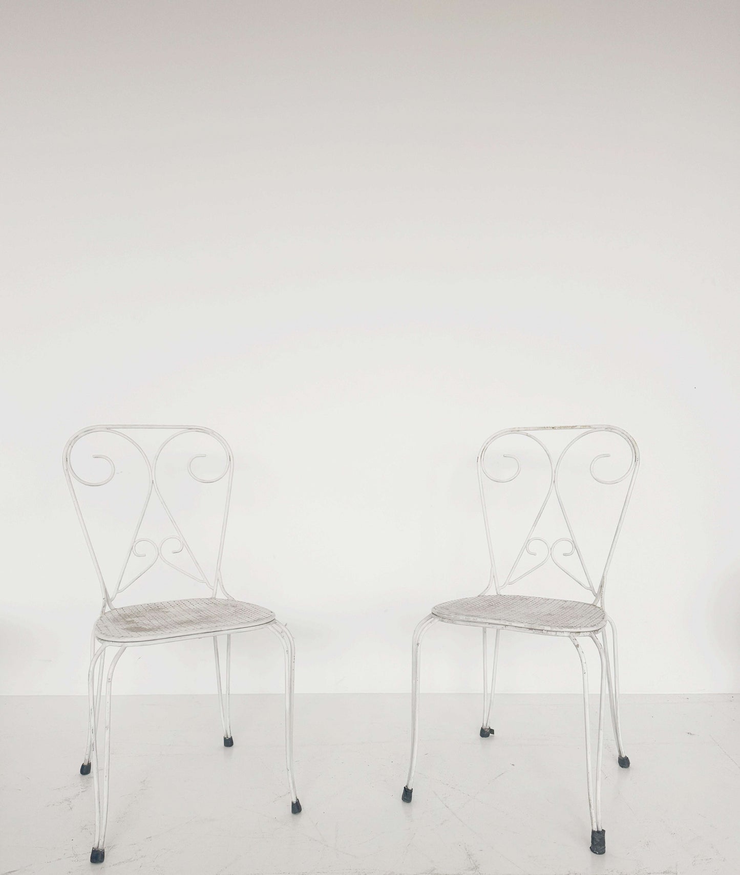 Pair of vintage wrought iron garden chairs