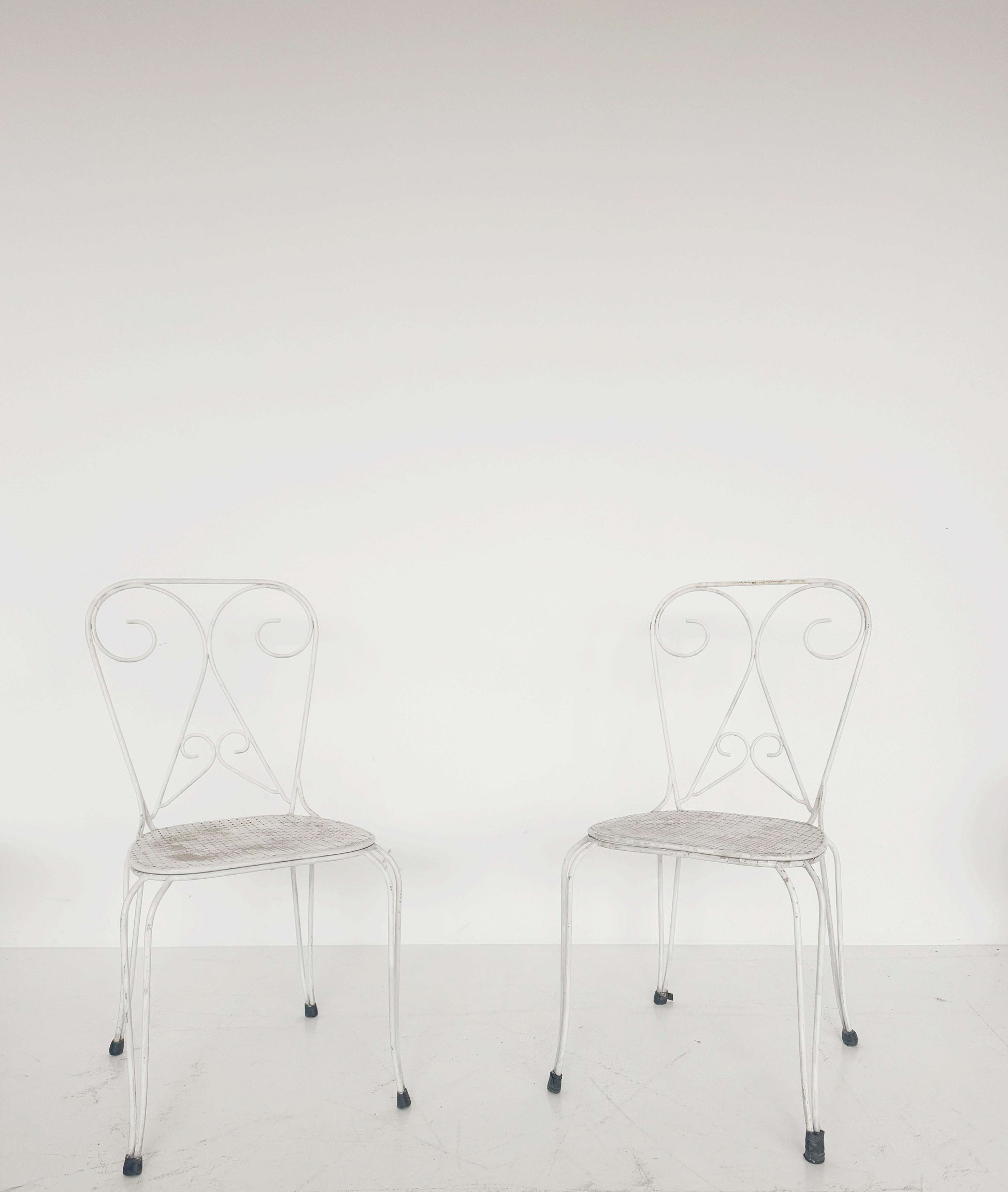 Pair of vintage wrought iron garden chairs