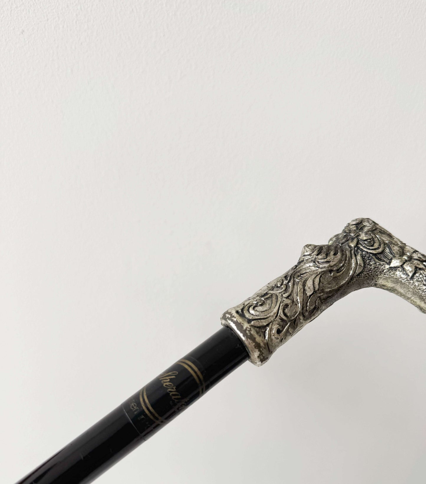 Walking stick with decorated metal handle