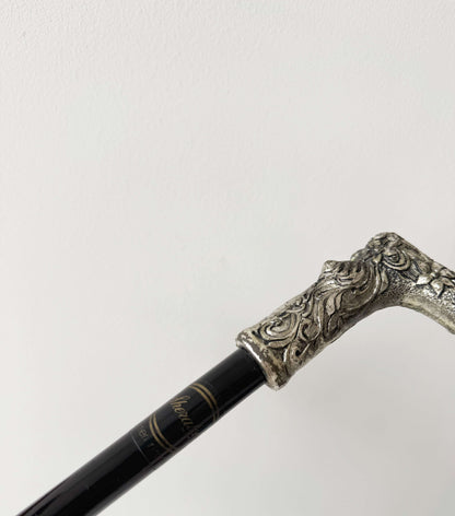 Walking stick with decorated metal handle
