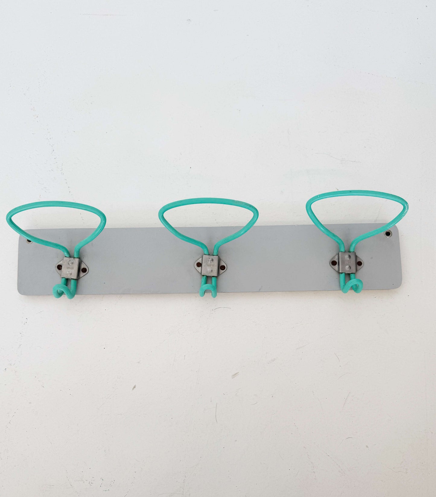 1960s wall mounted coat rack with coated metal hooks