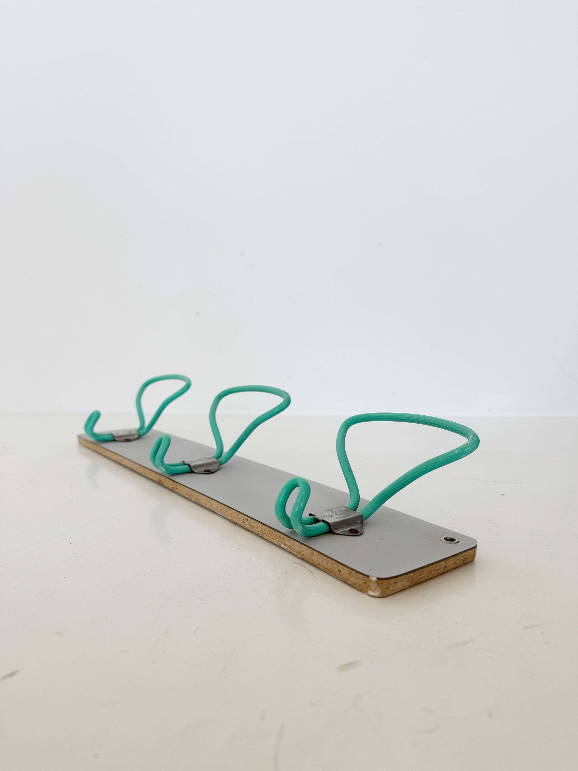 1960s wall mounted coat rack with coated metal hooks