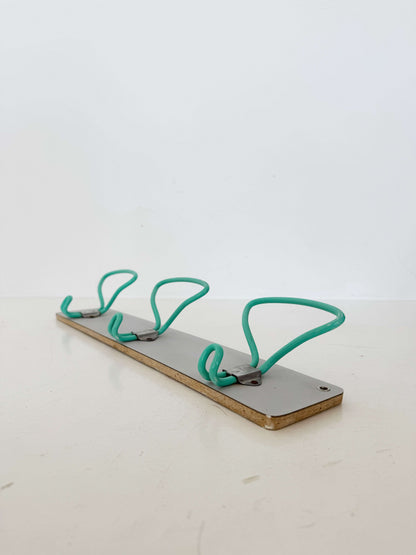 1960s wall mounted coat rack with coated metal hooks