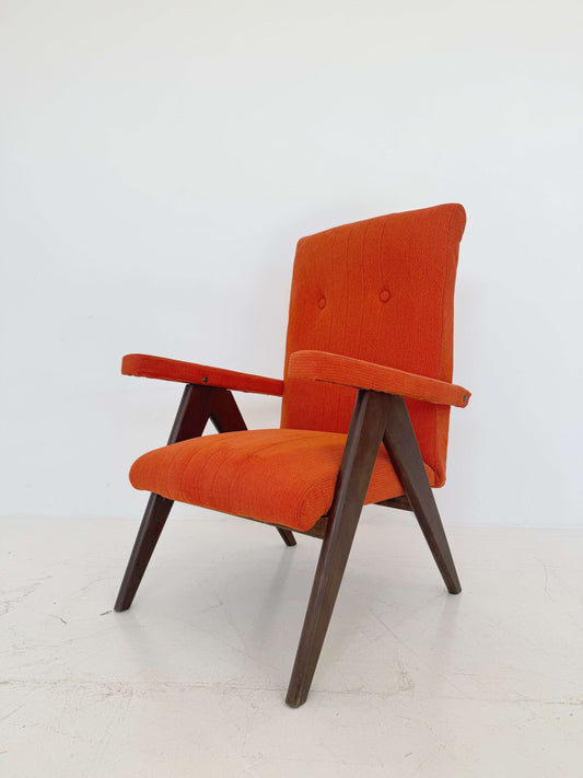A vintage reclining armchair, dating back to European production in the 1950s and 1960s
