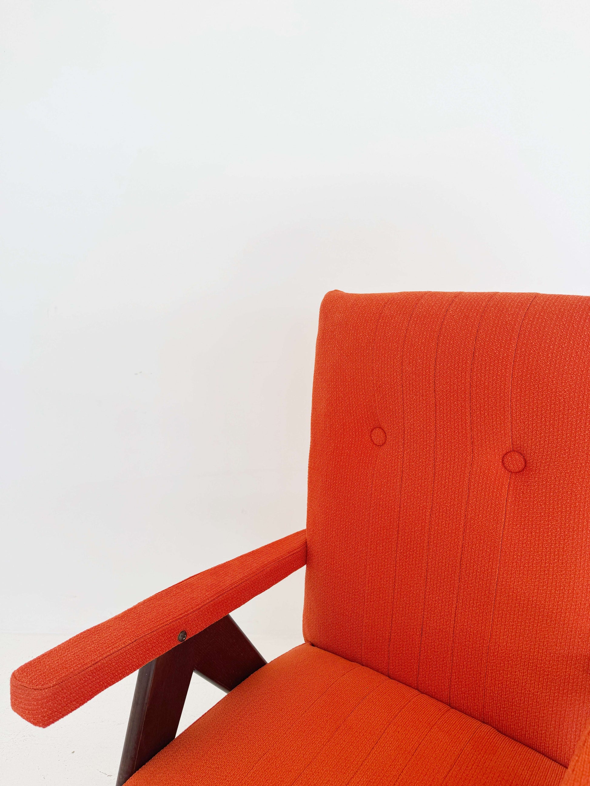 A vintage reclining armchair, dating back to European production in the 1950s and 1960s