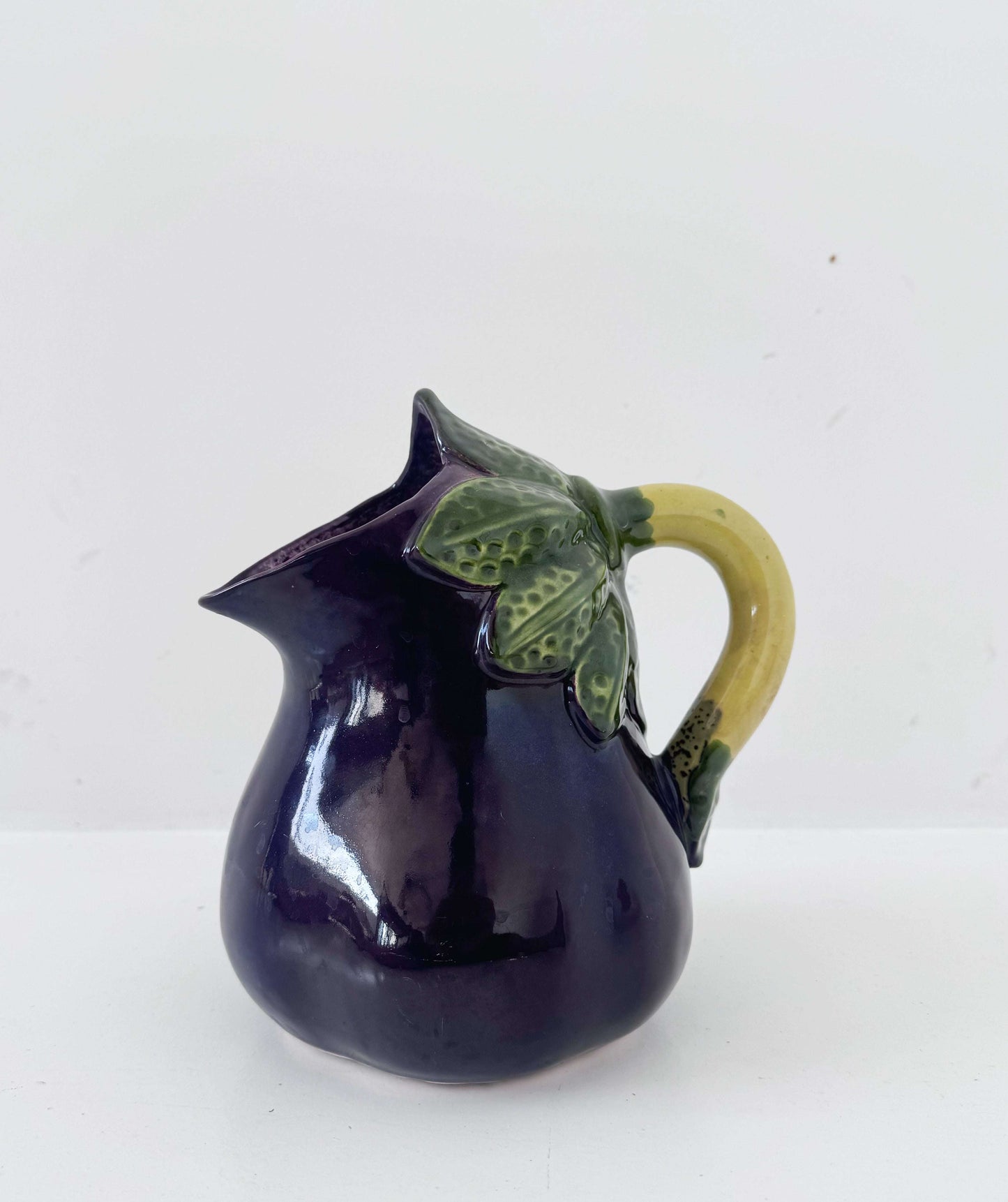 Glazed ceramic pitcher shaped like an eggplant