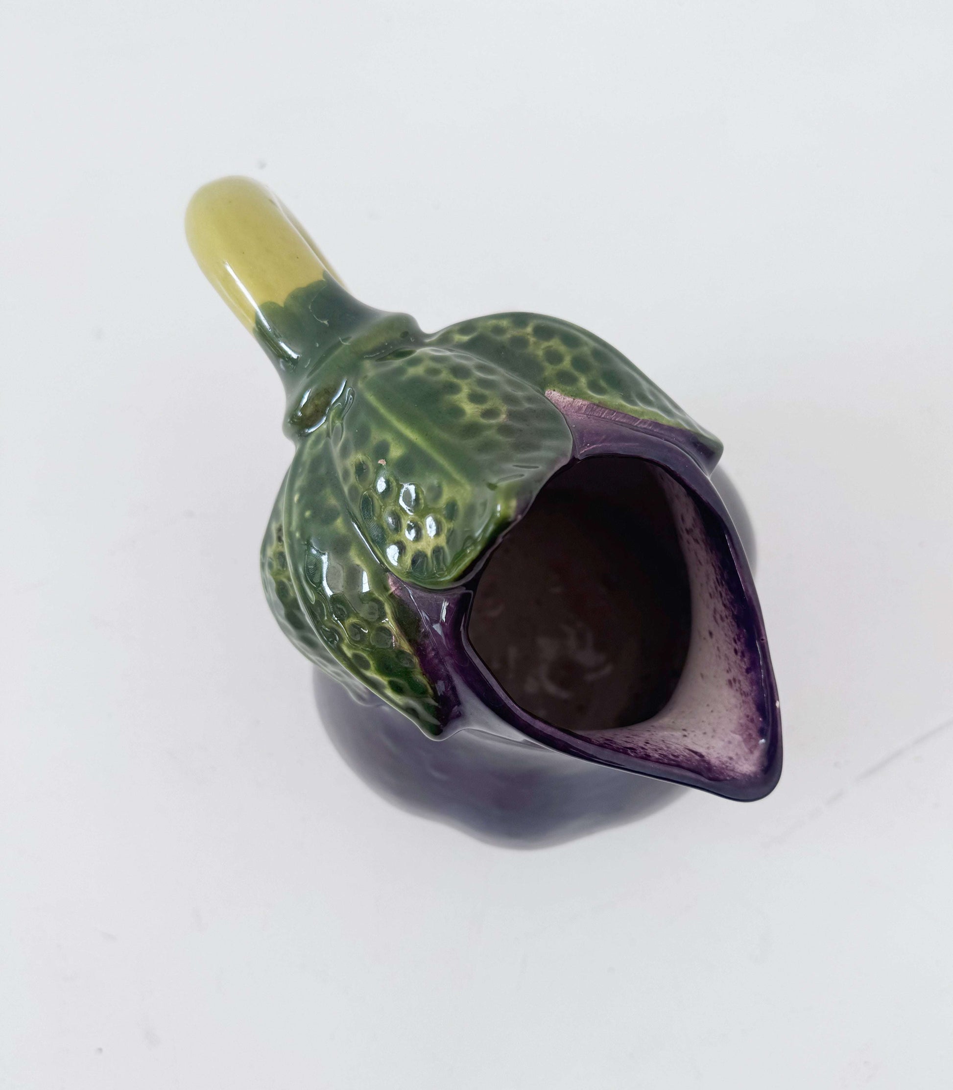 Glazed ceramic pitcher shaped like an eggplant