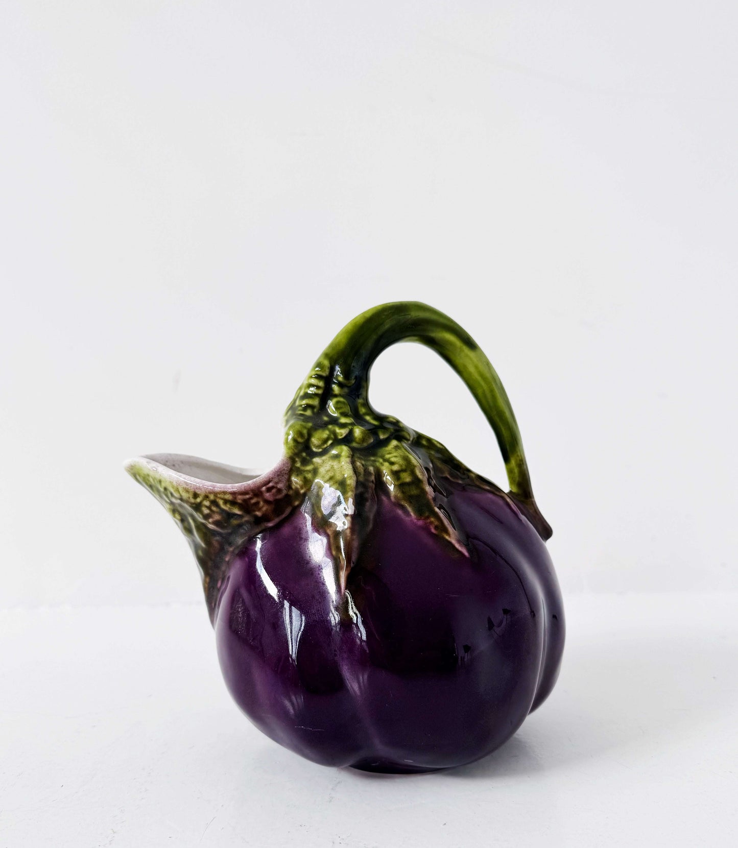 Glazed ceramic pitcher shaped like an eggplant