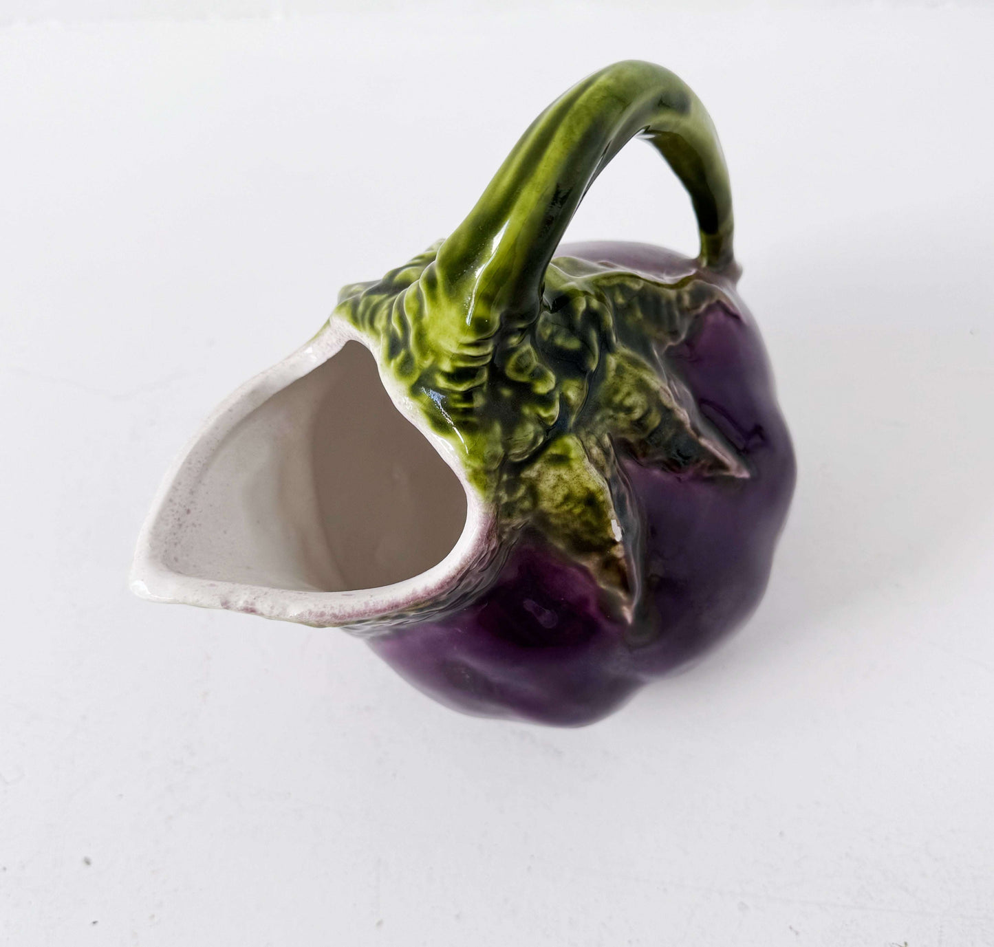 Glazed ceramic pitcher shaped like an eggplant