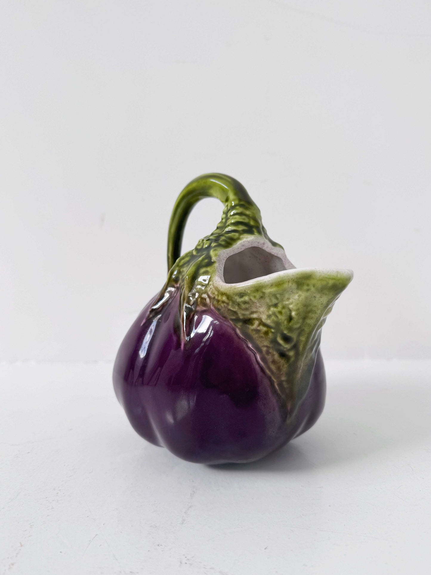 Glazed ceramic pitcher shaped like an eggplant
