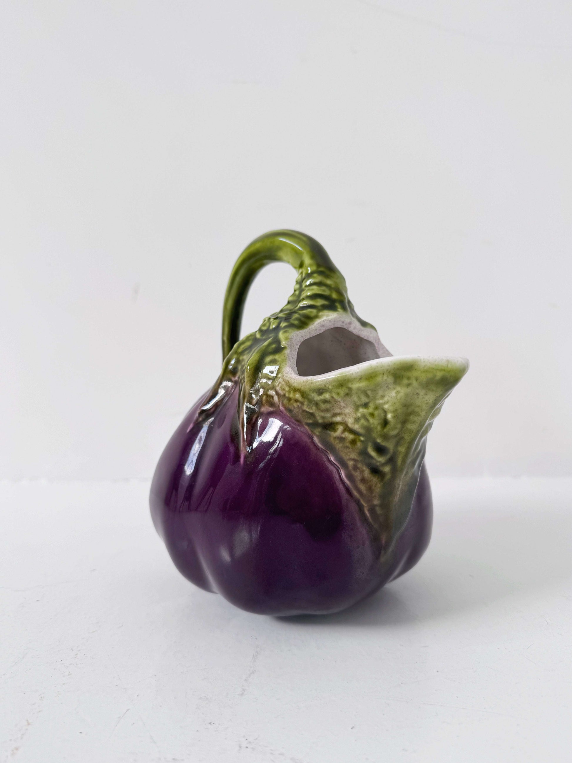 Glazed ceramic pitcher shaped like an eggplant