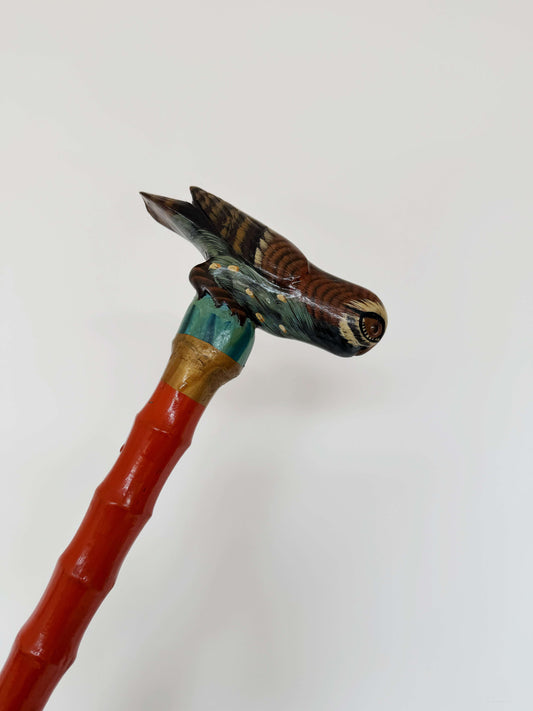 Vintage orange walking stick with decorative owl