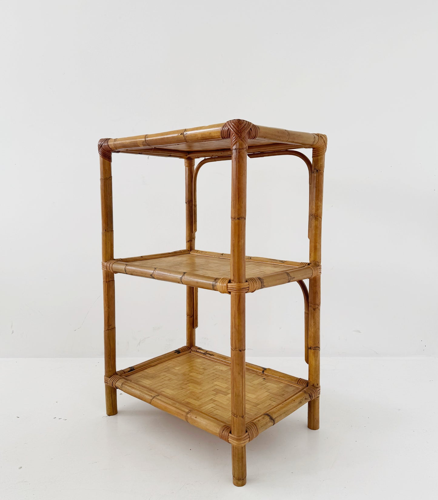 A 1970s bamboo bookcase with three shelves and woven details