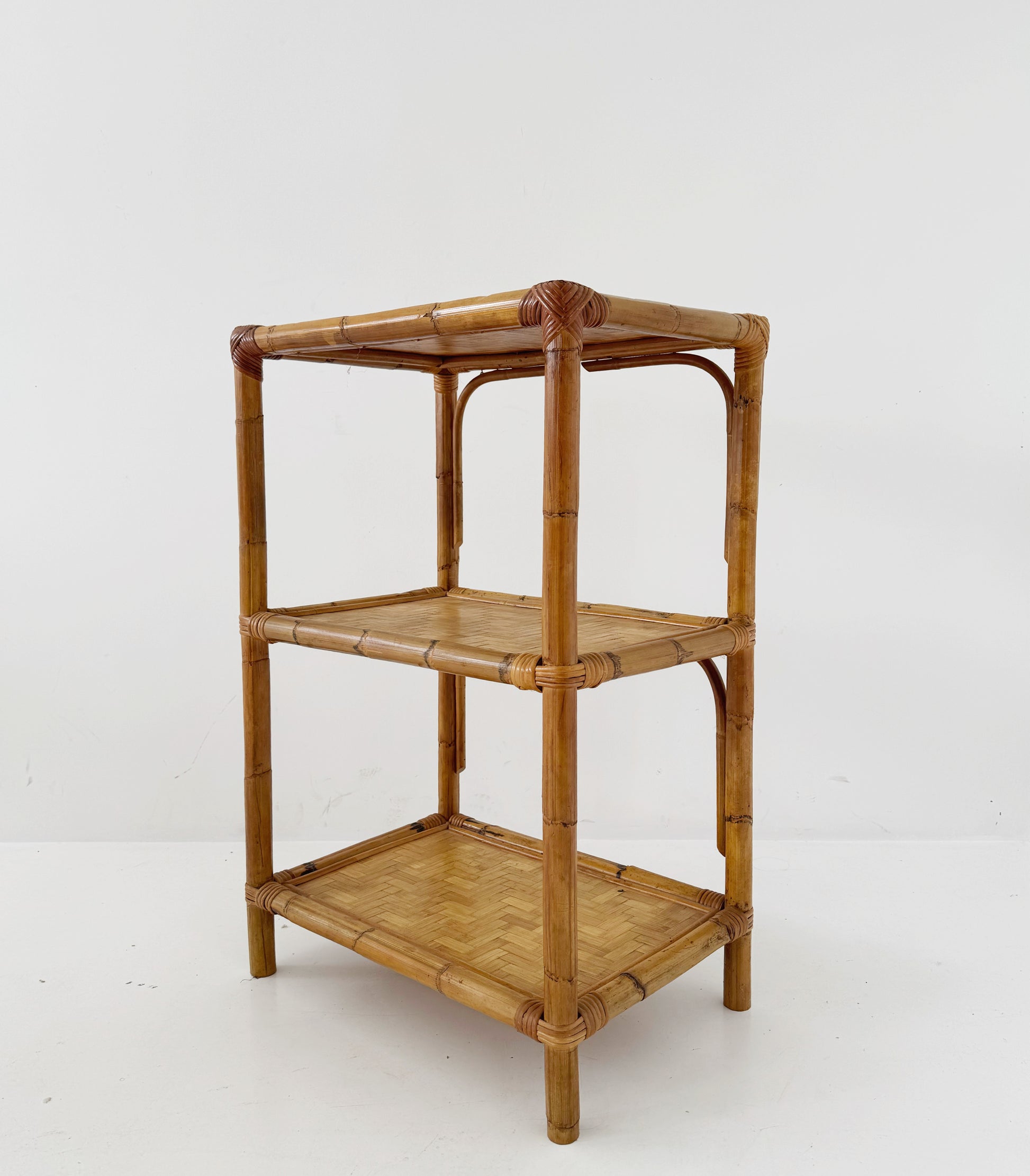 A 1970s bamboo bookcase with three shelves and woven details