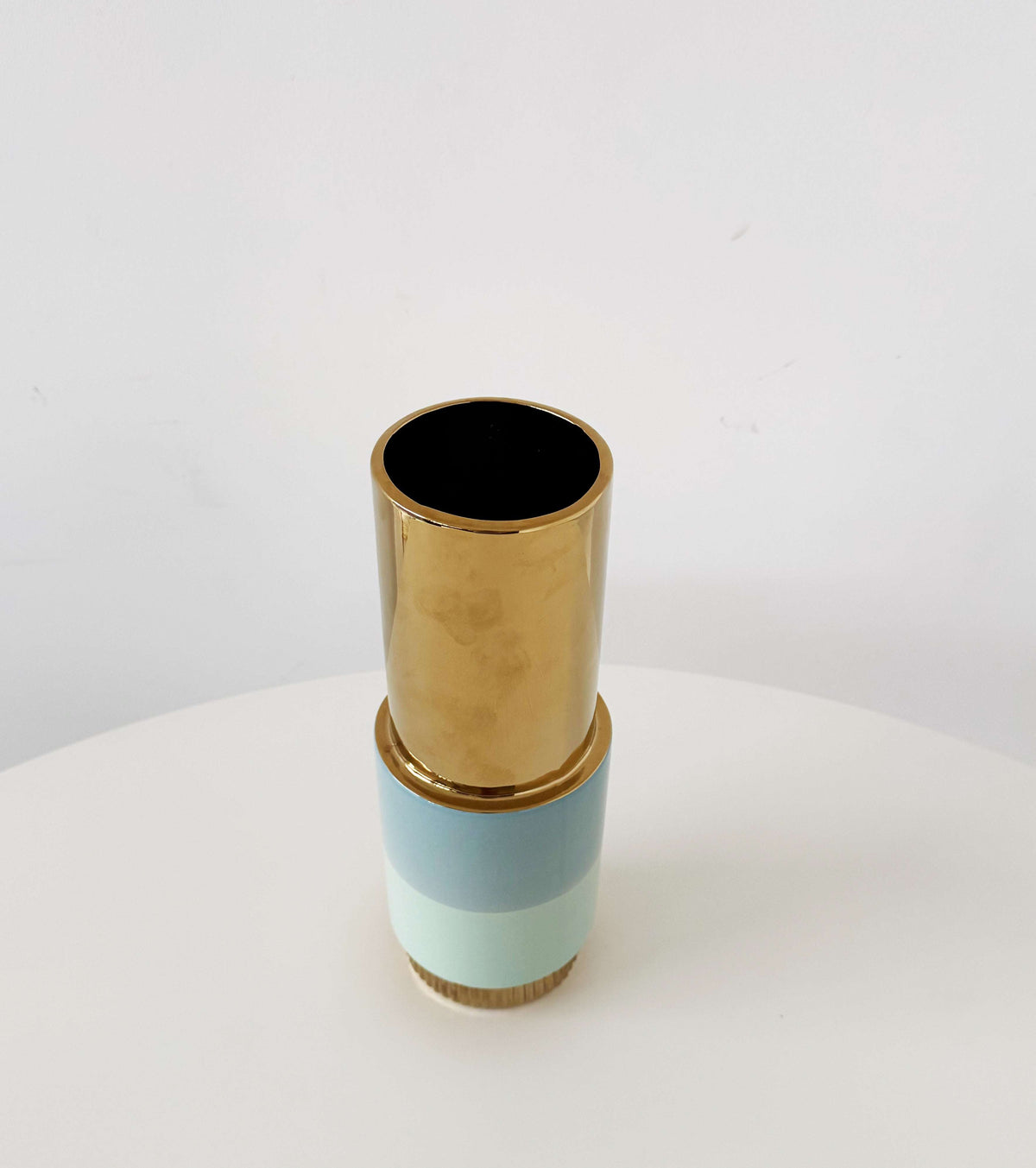 Sculptural ceramic vase in blue with gold accents
