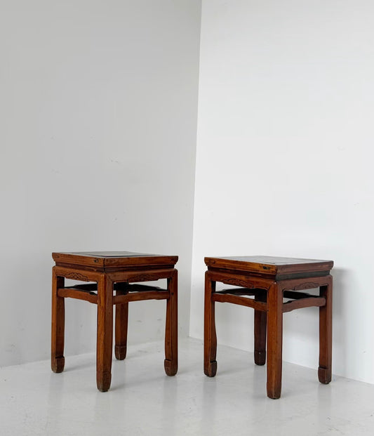 A pair of wooden nightstands with an Oriental aesthetic