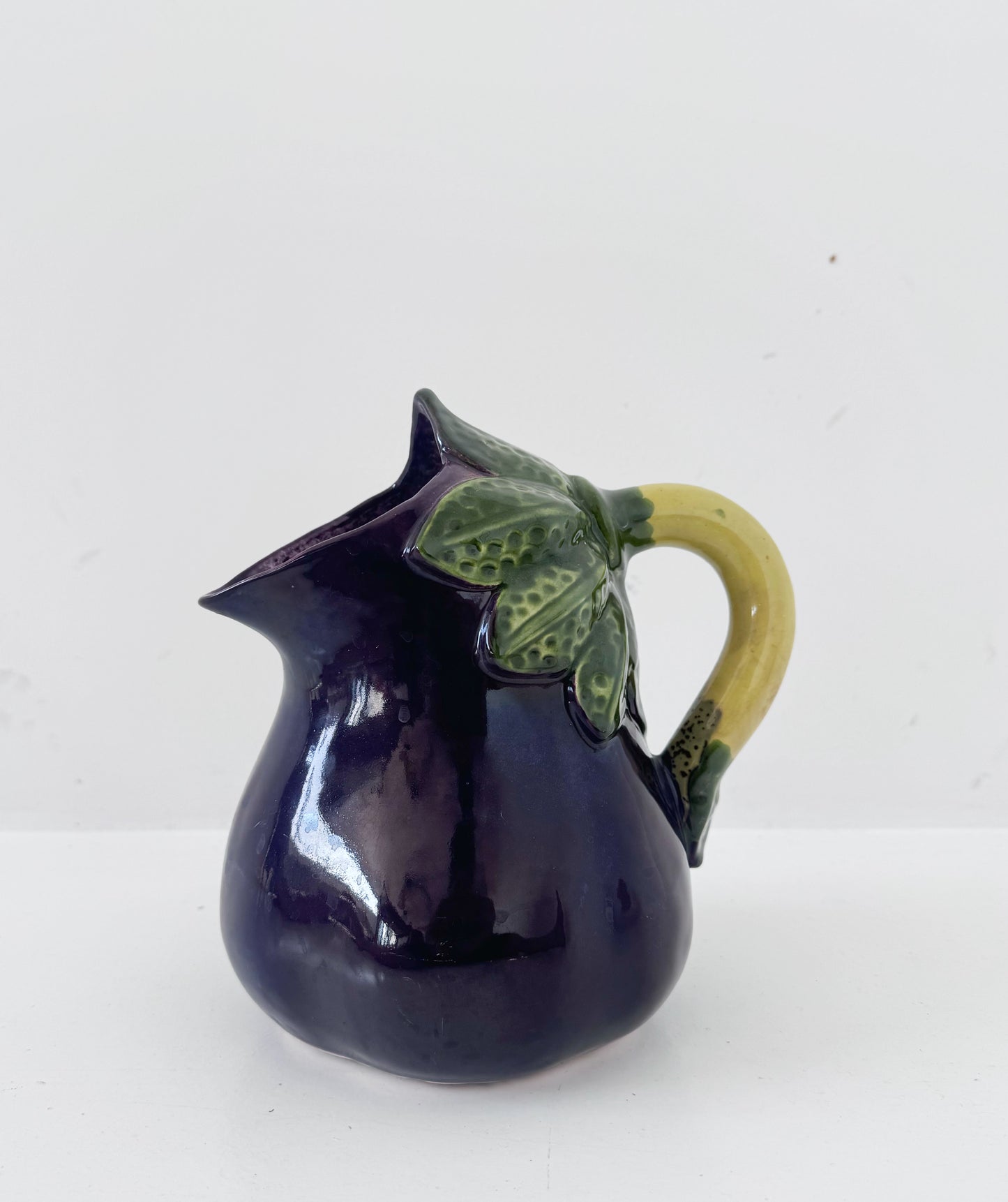Glazed ceramic pitcher shaped like an eggplant