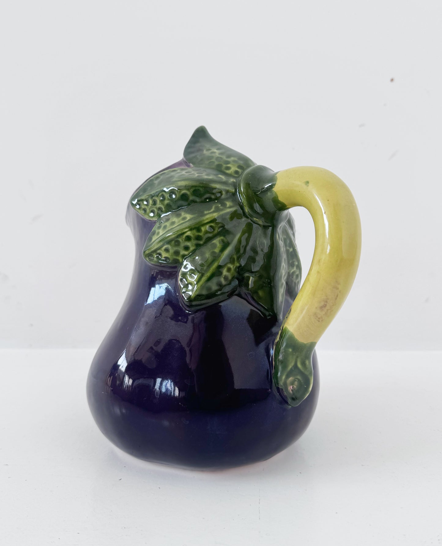 Glazed ceramic pitcher shaped like an eggplant