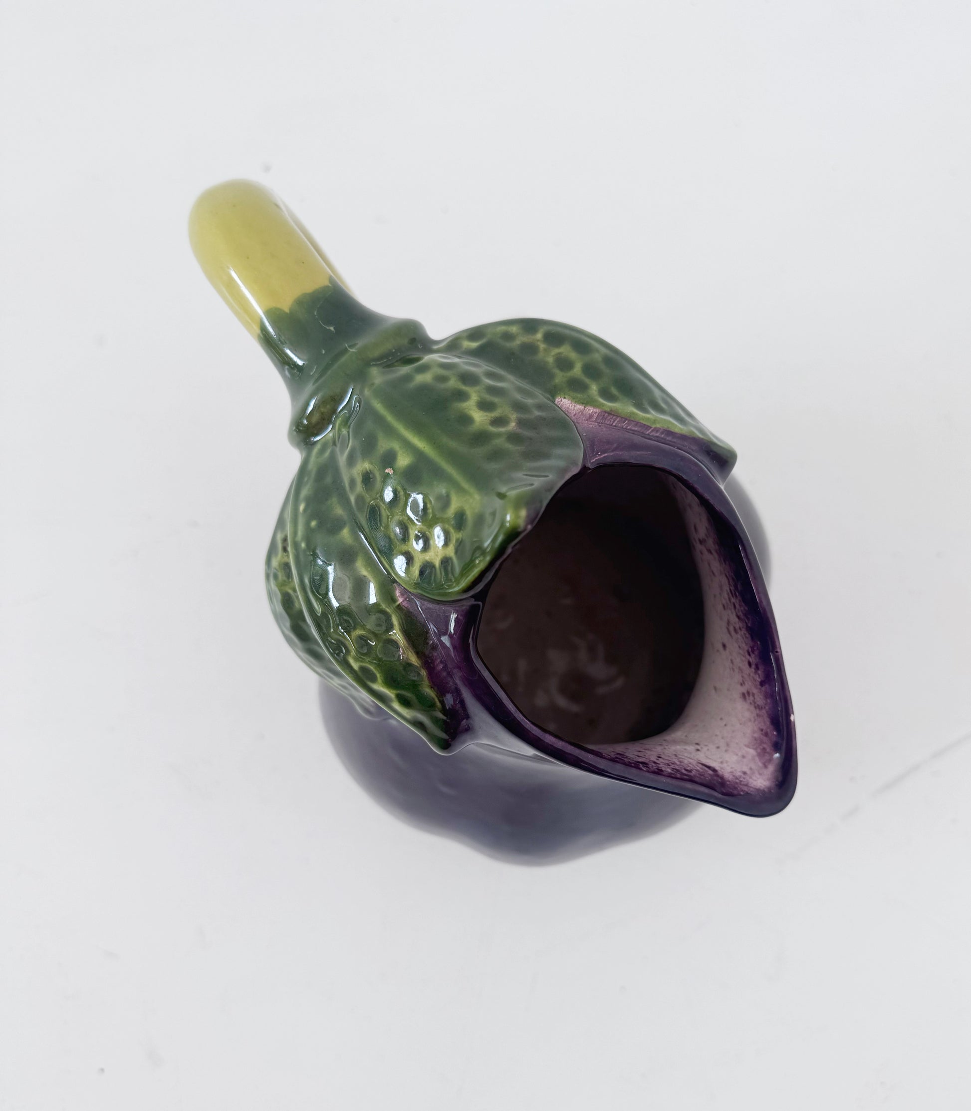 Glazed ceramic pitcher shaped like an eggplant